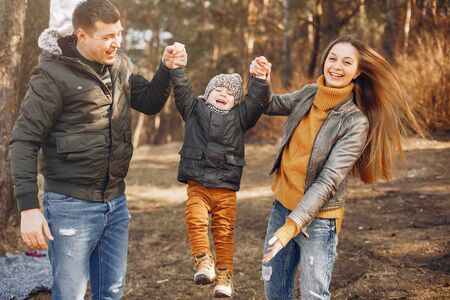 Cute family playing in a summer parkの写真素材