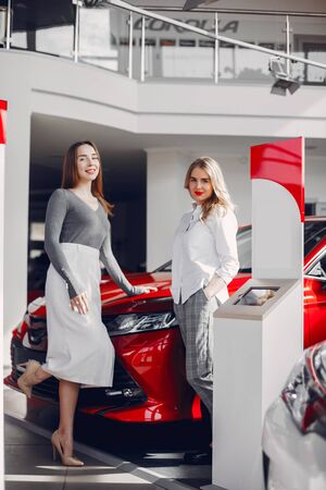 Two stylish women in a car salonの写真素材