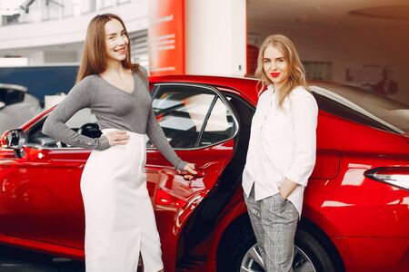 Two stylish women in a car salonの写真素材