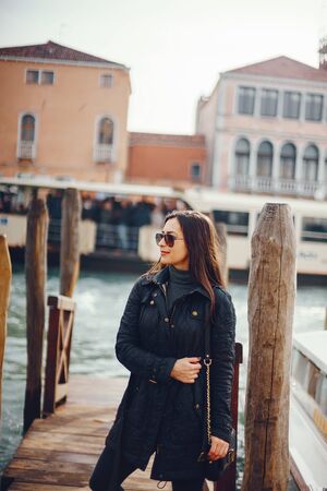 female tourist walking around and exploring veniceの写真素材
