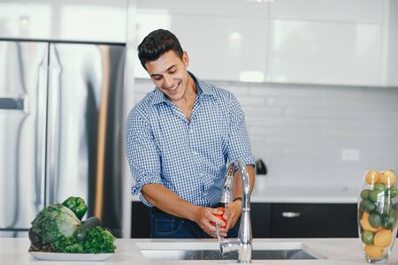 handsome man in a kitchenの写真素材