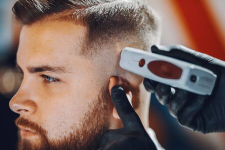 Stylish man sitting in a barbershopの写真素材