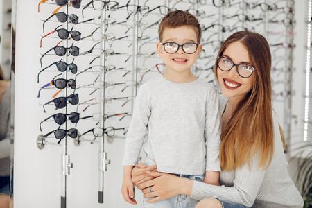 Mother with little son in the glasses storeの写真素材
