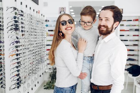 Family with little son in the glasses storeの写真素材