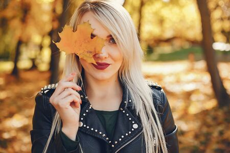 Beautiful girl standing in a summer parkの写真素材