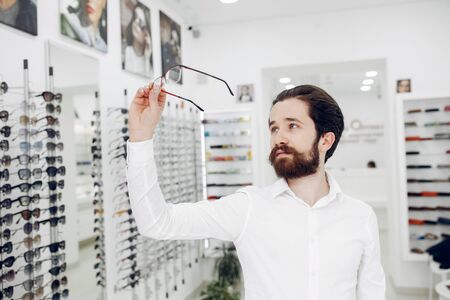 Handsome man in a optics shopの写真素材