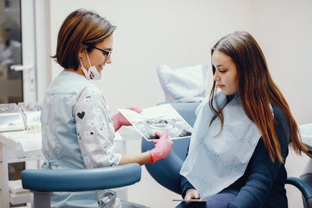 Beautiful girl sitting in the dentists officeの写真素材