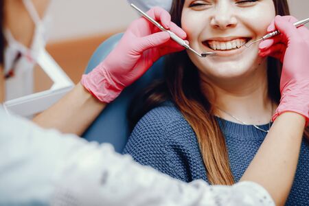 Beautiful girl sitting in the dentists officeの写真素材