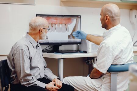 Old man sitting in the dentists officeの写真素材