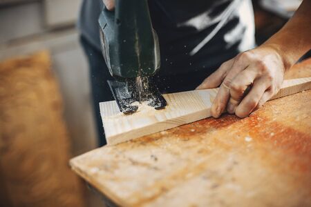 The carpenter works with a treeの写真素材