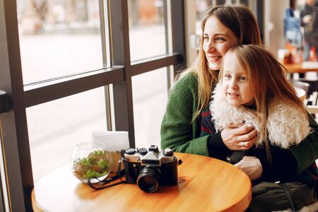 Cute and stylish family in a cafeの写真素材