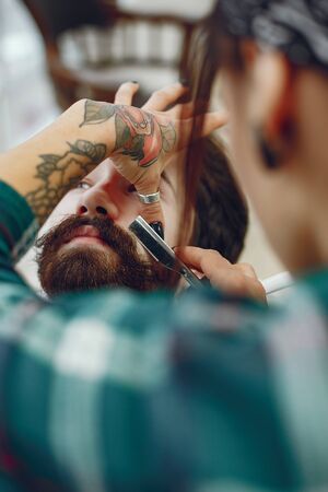 Stylish man sitting in a barbershopの写真素材