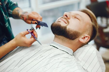 Stylish man sitting in a barbershopの写真素材