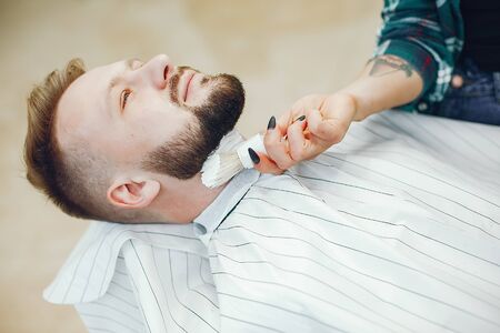 Stylish man sitting in a barbershopの写真素材
