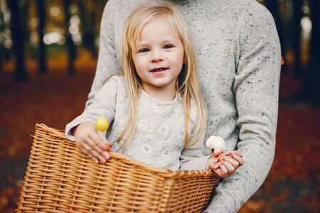 Cute family playing in a autumn parkの写真素材