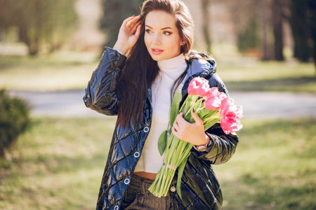 Elegant brunette in a summer park