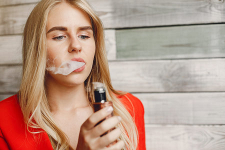 Stylish young girl in a city with vape