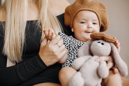 Elegant mother with cute little daughter in a studioの写真素材
