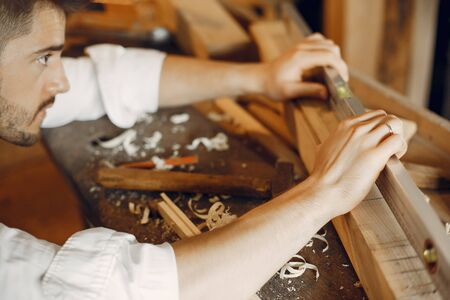 Handsome carpenter working with a woodの写真素材