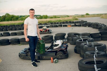 Handsome man in a karting with a carの写真素材