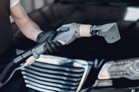 Man washing his car in a garageの写真素材