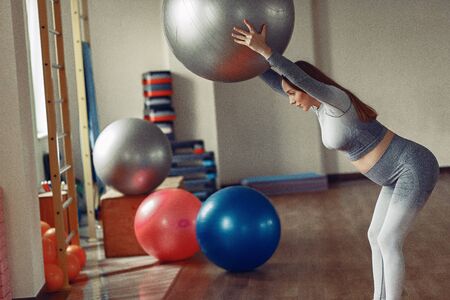 Pregnant woman training in a gymの写真素材
