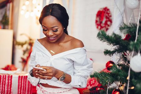 Elegant black girl in the Christmas decorationsの写真素材