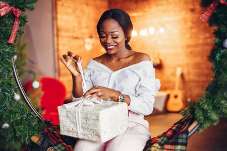 Elegant black girl in the Christmas decorationsの写真素材