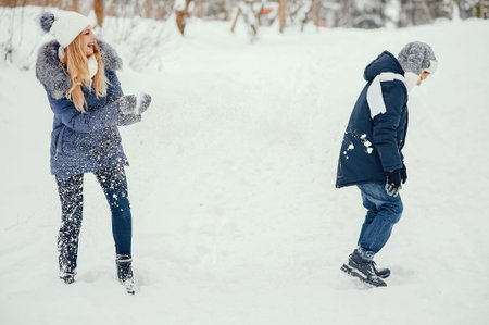 Mother with cute son in a winter oark