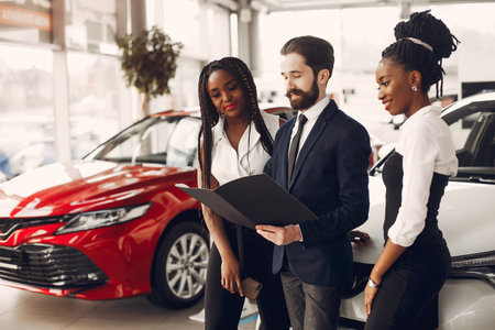 Two stylish black woman in a car salon