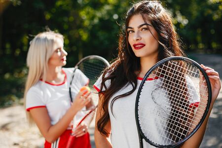 Beautiful and stylish girls in a summer parkの写真素材