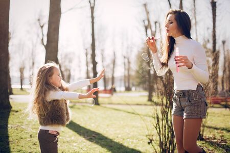 Cute and stylish family in a spring parkの写真素材