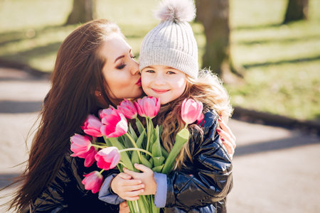 Cute and stylish family in a spring parkの写真素材