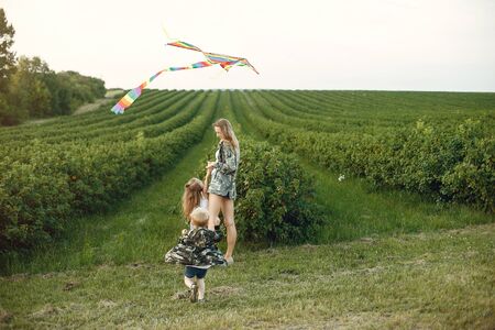 Mother with two children. Family with a Kite. Brother with a little sisterの写真素材
