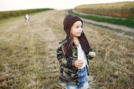 Cute little child in a summer field with a Kiteの写真素材