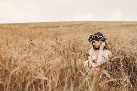 Elegant mother with cute little daughter in a fieldの写真素材