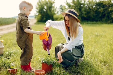 Beautiful mother with little son in a summer fieldの写真素材