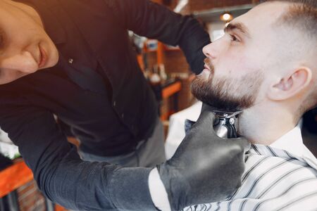 Stylish man sitting in a barbershopの写真素材