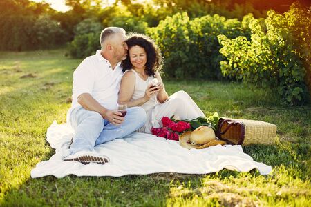 Beautiful adult couple spend time in a summer fieldの写真素材
