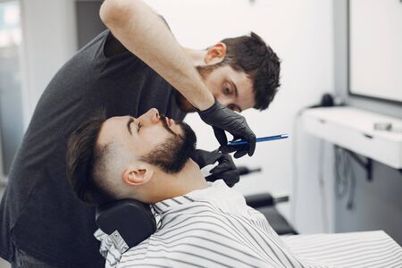 Stylish man sitting in a barbershopの写真素材