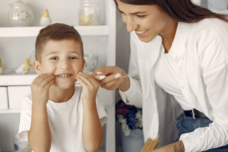 Mother with little son having fun at home