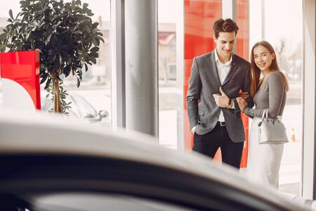 Elegant couple in a car salonの写真素材