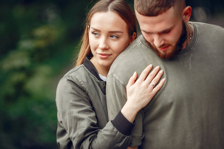 Beautiful couple spend time on a summer forest