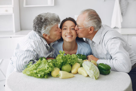 Old couple in a kitchen with young granddaughter