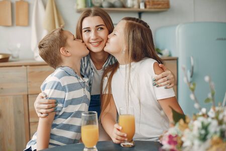 Beautiful big family prepare food in a kitchenの写真素材