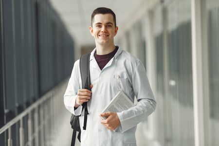 Medical student in with a backpack is standing in a modern clinicの写真素材