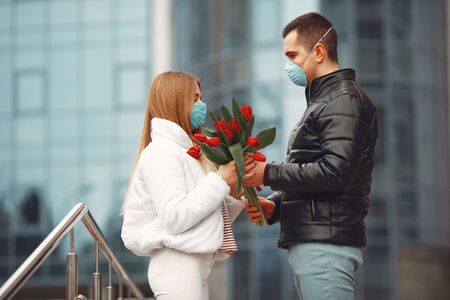 European couple in masks is standing togetherの写真素材