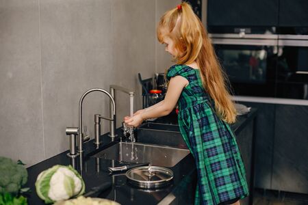 Little girl in a kitchenの写真素材