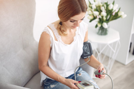 Woman measures herself pressure at home