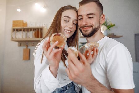 Beautiful couple spend time in a kitchenの写真素材